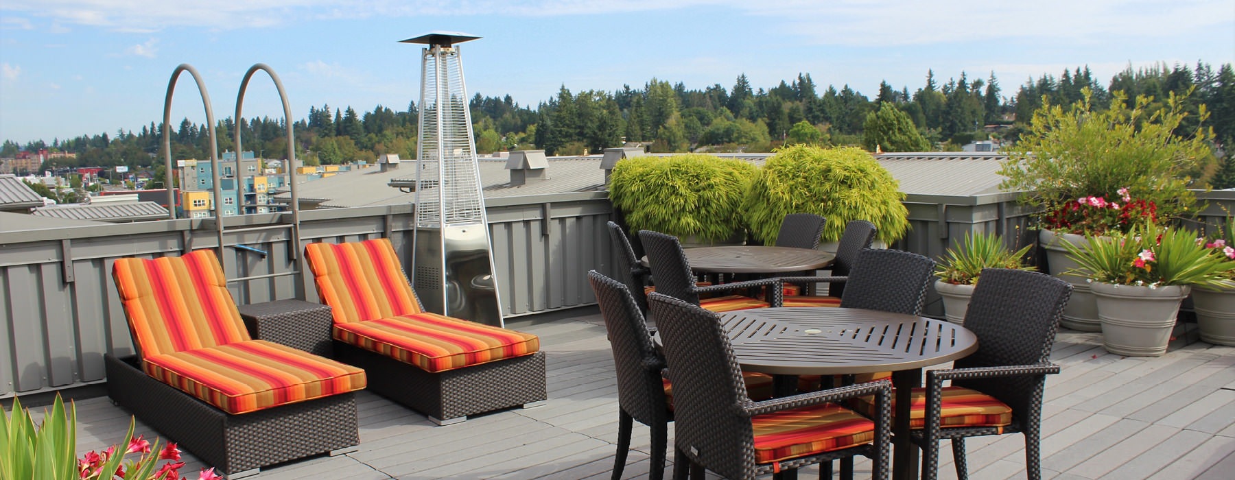 rooftop deck with lounge chairs, tables, and heaters